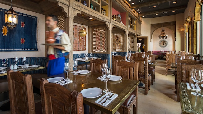 A server carries a tray in the dining area of a Moroccan themed restaurant