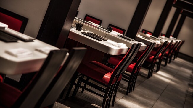 A row of alcoves, each with grill tables and chairs