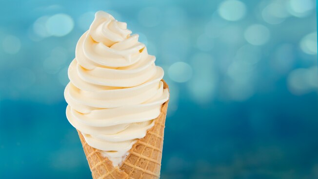 A waffle cone filled with soft-serve vanilla ice cream