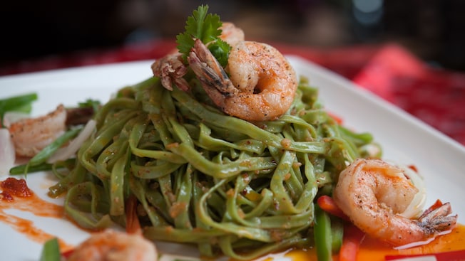 A plate of spinach linguine with shrimp
