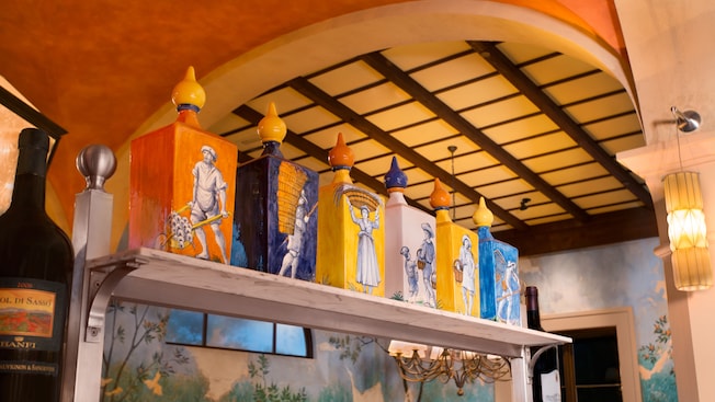 Painted decorative bottles on a high shelf in the dining area