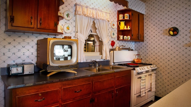 1950s-inspired kitchen with stove, cabinetry, countertop, TV set and 1950's knick-knacks