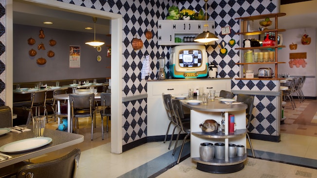 Dining area of 50's Prime Time Café with tables surrounded by mid-50's knick-knacks and memorabilia