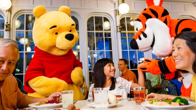 Pooh and Tigger pay a visit to a dinner table with 3 Guests