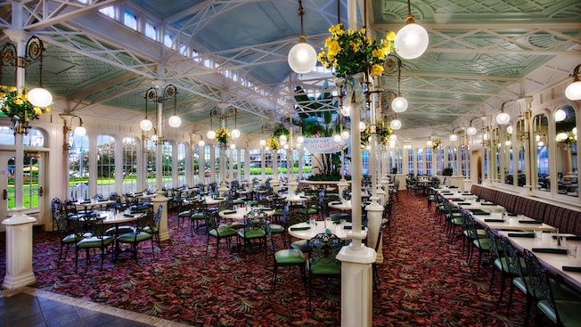 Main dining floor with round tables and banquette tables along the wall