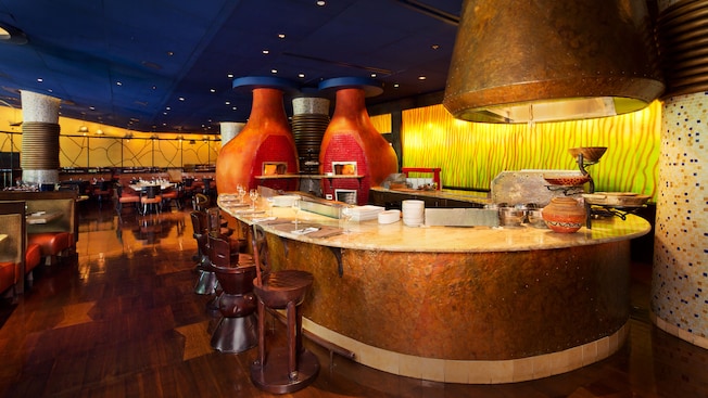 Bar and open kitchen with 2 wood-fired clay ovens in dining room 