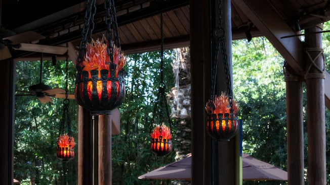 Red lights cradled in small iron baskets hanging from the ceiling of the bar patio