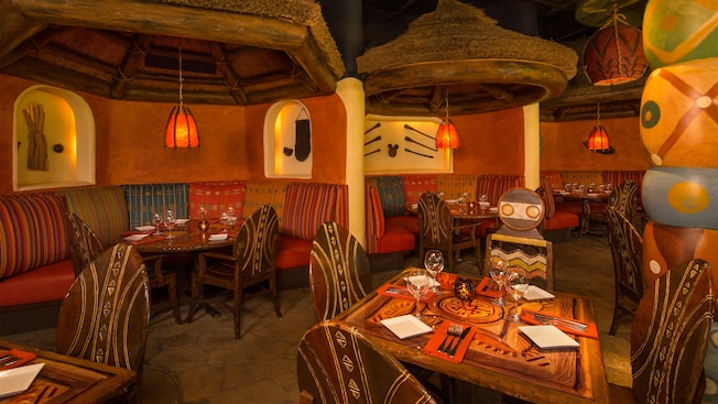 Tribal-design tables under hanging thatched domes with lanterns