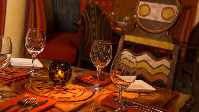 Close-up of a table set with wine glasses and silverware