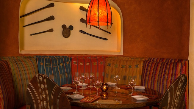 Circular booth in front of wall alcove with Hidden Mickey