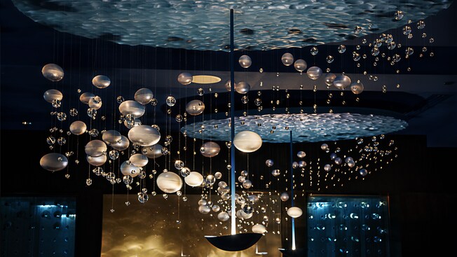 A close-up of glass bubbles hanging from a ocean-like chandeliers