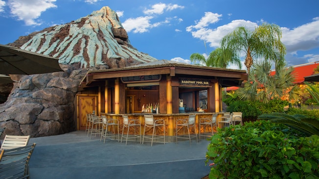Exterior view of Barefoot Pool Bar at Disney's Polynesian Village Resort, with Nanea Volcano in the background