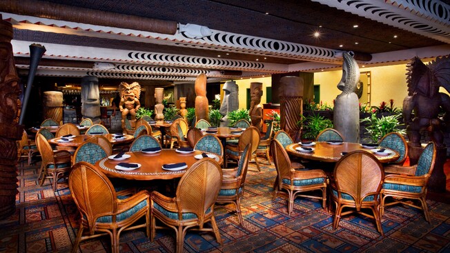 Dining room in a South Seas decor surrounded by tiki statues