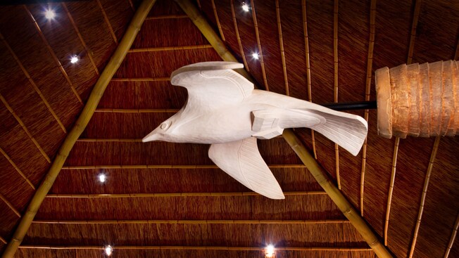 Seagull sculpture hanging from thatched ceiling