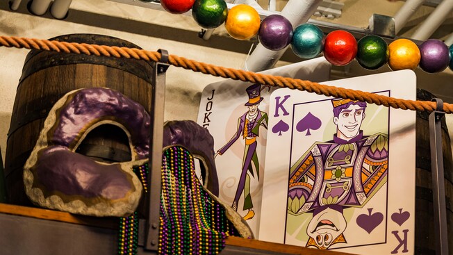 A New Orleans themed display with a Mardi Gras mask, beads and playing cards