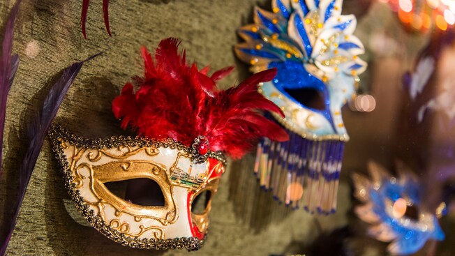 Three Mardi Gras masks hung on a wall