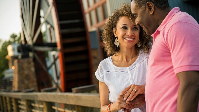 A husband and wife hold hands outside Riverside Mill Food Court