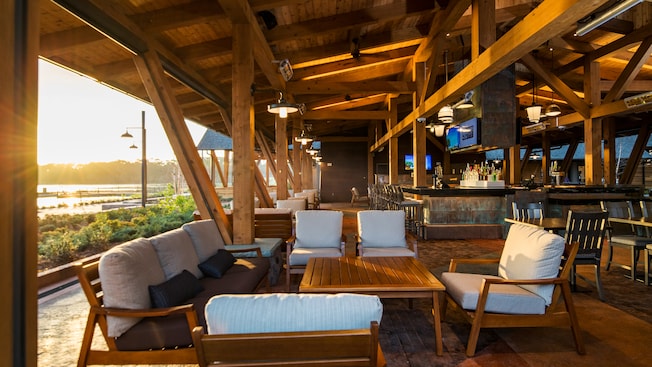 The open air interior of Geyser Point Bar & Grill with a spacious bar area and assorted chair and table setups