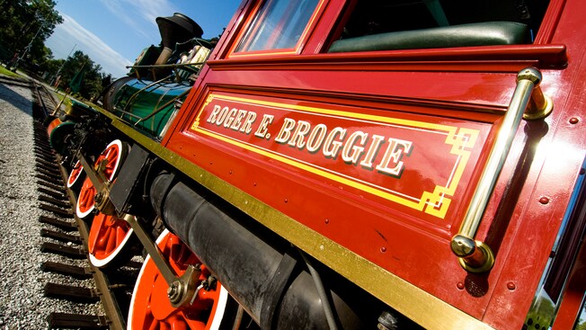 Angled view of a red steam engine with the name 'Roger E. Broggie' painted on it