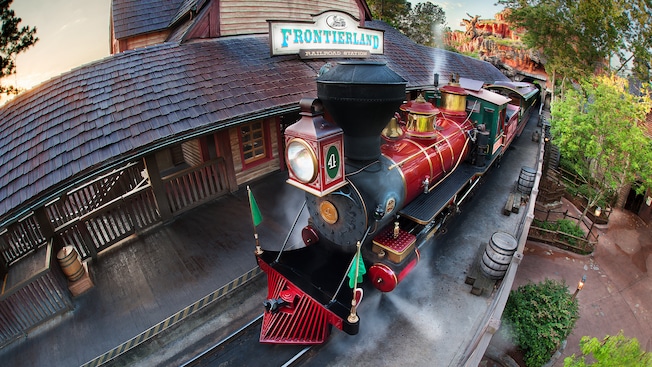 A train sits at the rustic Walt Disney World Railroad - Frontierland Station in Magic Kingdom park