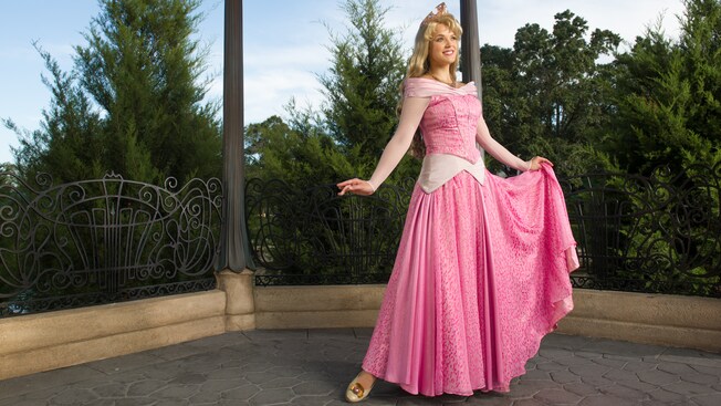 Princess Aurora poses in the gardens of the France Pavilion at Meet Prince Aurora in France at Epcot