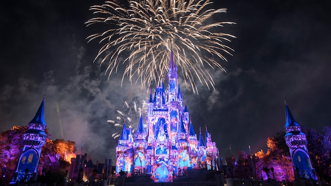A fireworks and laser light show occurring above Cinderella Castle