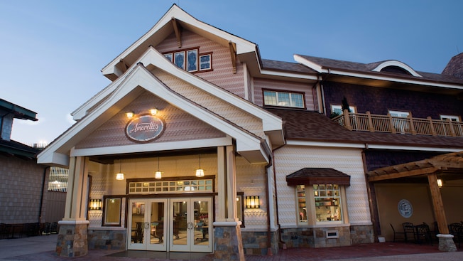 The 2-story building housing Amorette’s Patisserie features gingerbread style siding, a roof with 3 sharp-peaked gables and a covered portico with 2 sets of double entry doors