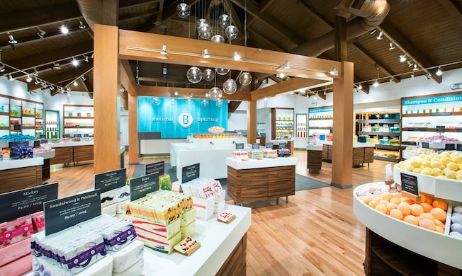 The modern and spacious interior of Basin with organized displays of assorted soaps, bath bombs and body products