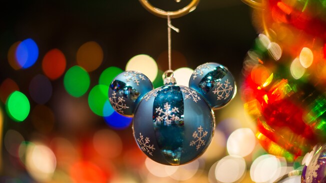 A Mickey Mouse Icon ornament is decorated with snowflakes