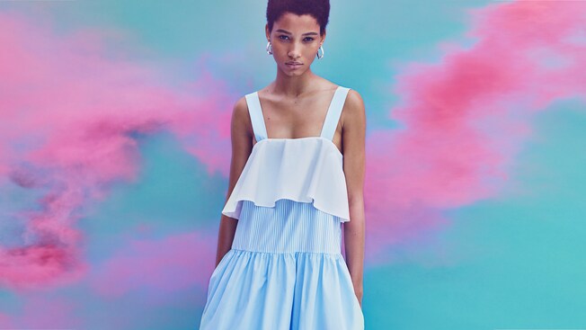 A woman models a tiered ruffle tank dress