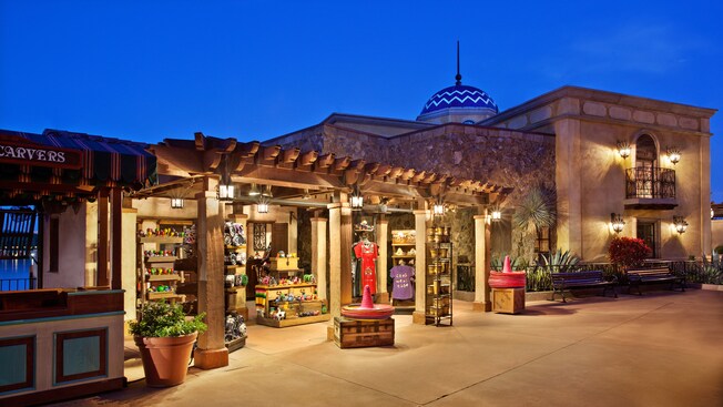 Street view of El Ranchito del Norte in the Mexico Pavilion at Epcot, lit up at night