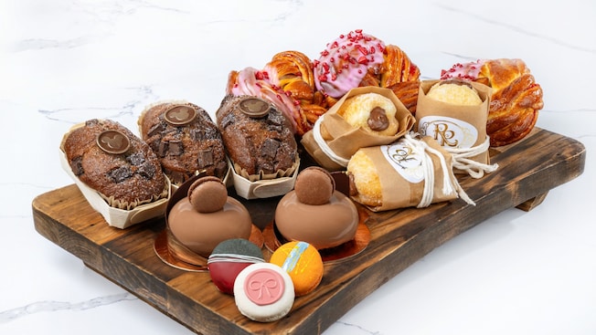 A tray with Banana Bread, Raspberry Brioche, Hazelnut-Chocolate Bomboloni and Trois Chocolat pastries