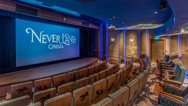 A movie theater with the words 'Never Land Cinema' projected on the screen A movie theater with the words 'Never Land Cinema' projected on the screen