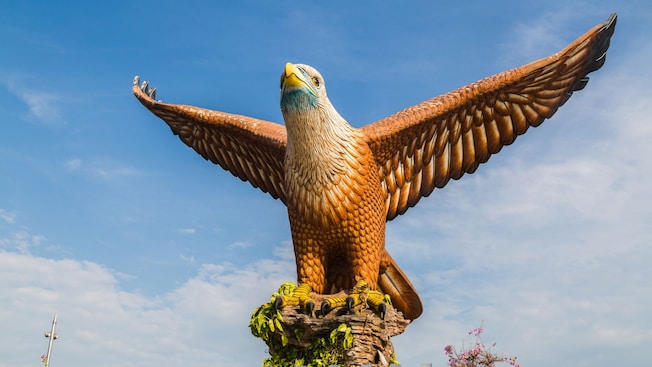 Langkawi's eagle statue with wings fully spread, perched on a rocky base Langkawi's eagle statue with wings fully spread, perched on a rocky base