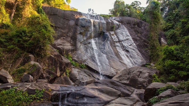Waterfall cascading down a rocky cliff in Langkawi, Malaysia