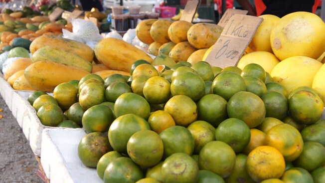Tangerines, papayas and canary melons displayed at an open air market in Langkawi