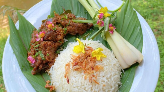 A traditional Malaysian dish featuring marinated meat, fried rice and celery stalks