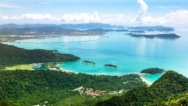 Langkawi's coastline including the bay, scattered forested islands, a marina and distant mountain ranges Langkawi's coastline including the bay, scattered forested islands, a marina and distant mountain ranges