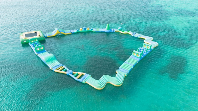 A large inflatable water obstacle course floating in the ocean A large inflatable water obstacle course floating in the ocean