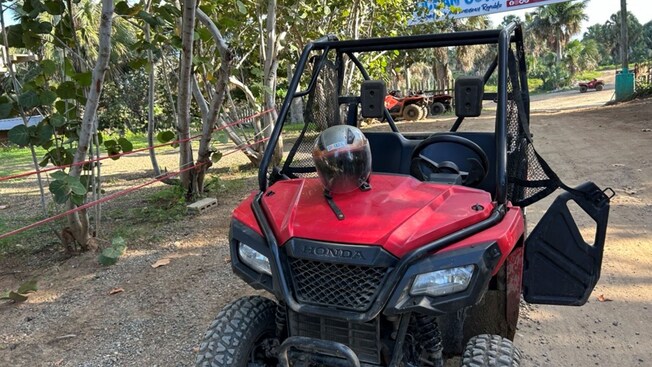 A dune buggy with a helmet on the hood
