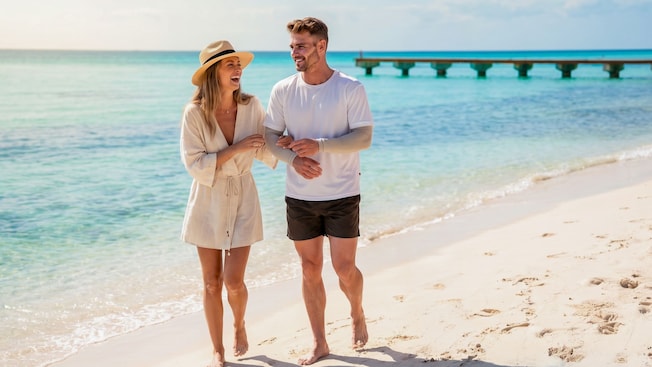 A couple strolling along the shoreline at Kuza Beach in Cozumel, Mexico