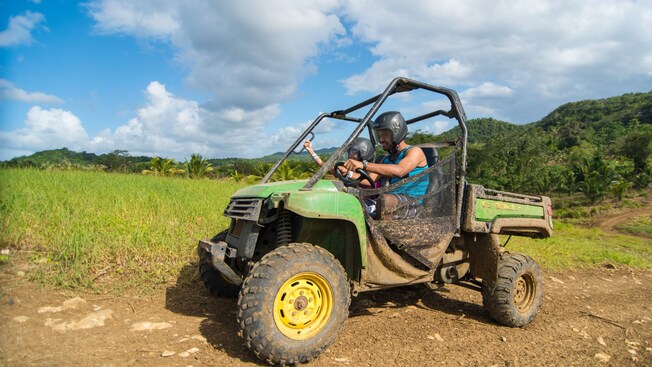 Guests driving a dune buggy on a dirt trail