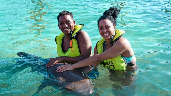 Guests petting a nurse shark while standing in chest deep water Guests petting a nurse shark while standing in chest deep water