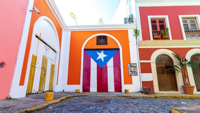 The flag of Puerto Rico painted on the large door of a Spanish Colonial style building The flag of Puerto Rico painted on the large door of a Spanish Colonial style building