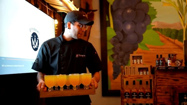 A server carrying a tray of sangria glasses A server carrying a tray of sangria glasses