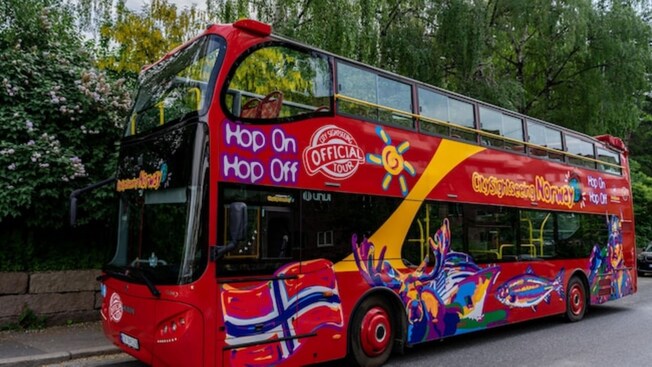 A Hop On, Hop Off double decker sightseeing bus with an open top
