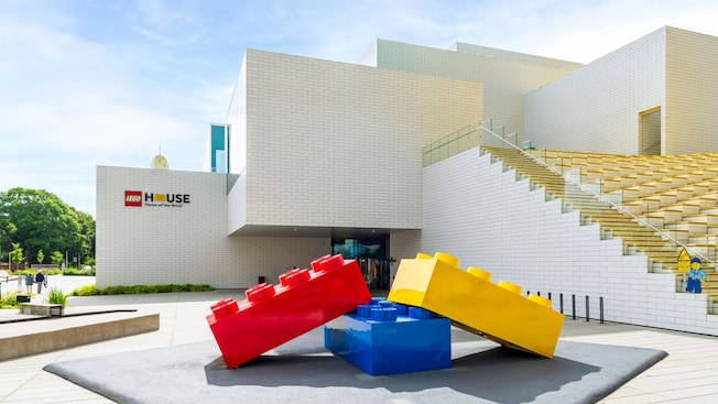 The modern Lego House with a large Lego brick sculpture in the front plaza The modern Lego House with a large Lego brick sculpture in the front plaza
