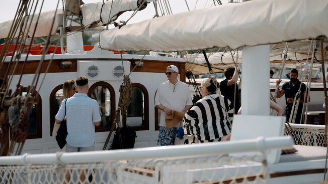 Guests gathered on the deck of a sailing yacht