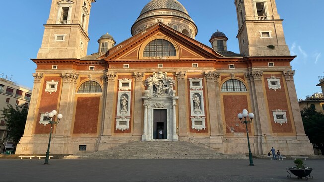 The facade of the Dome of the Basilica of Santa Maria Assunta in Genoa with 2 bell towers and a central dome