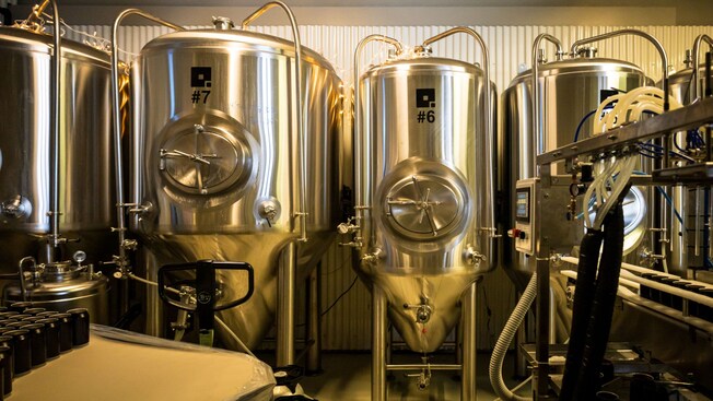 Four steel fermentation tanks at Hombursund Brewery